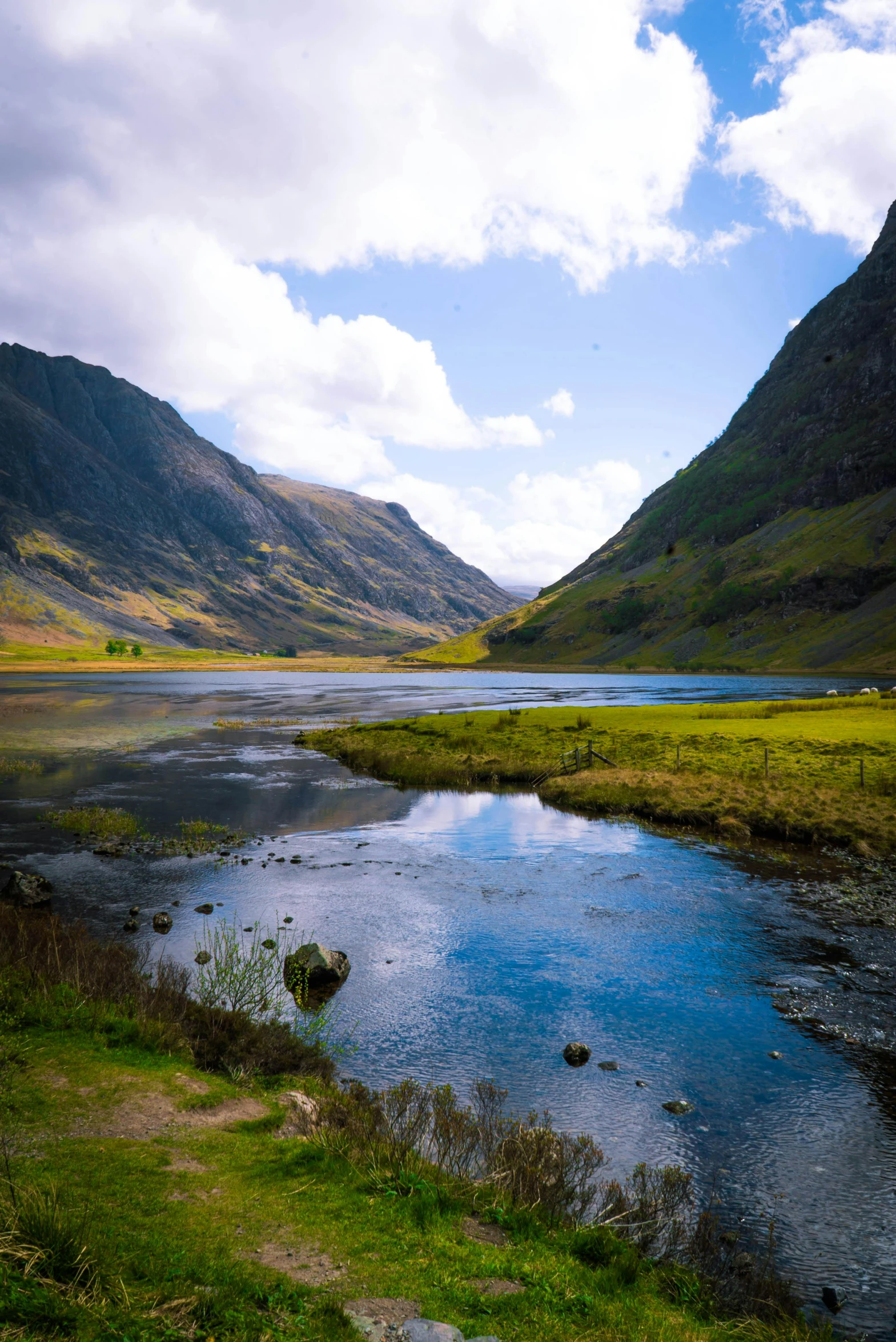 a river running through a lush green valley, by Colin Middleton, pexels contest winner, hurufiyya, a photo of a lake on a sunny day, highlands, honey, shallow water