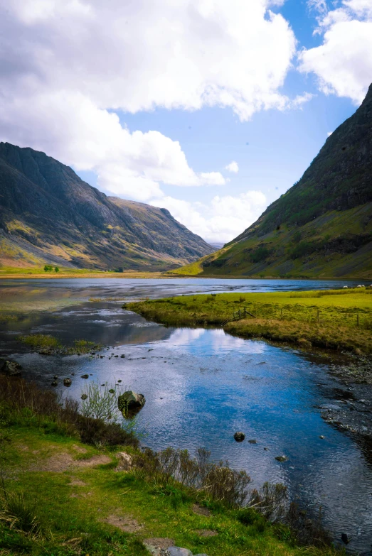 a river running through a lush green valley, by Colin Middleton, pexels contest winner, hurufiyya, a photo of a lake on a sunny day, highlands, honey, shallow water