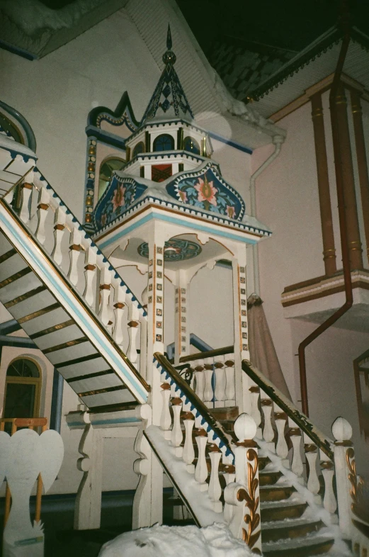 a clock tower sitting next to a set of stairs, inspired by Nikolai Alekseyevich Kasatkin, art nouveau, mosque synagogue interior, 1 9 9 1, elaborate costume, teruel city in 1989