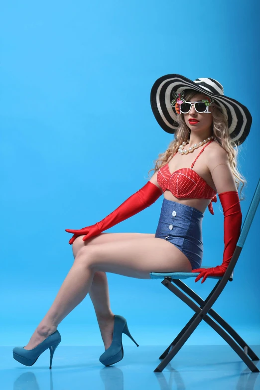 a woman sitting on top of a chair next to a chair, inspired by Bunny Yeager, pop art, wearing blue sunglasses, red gloves, ava max, slide show