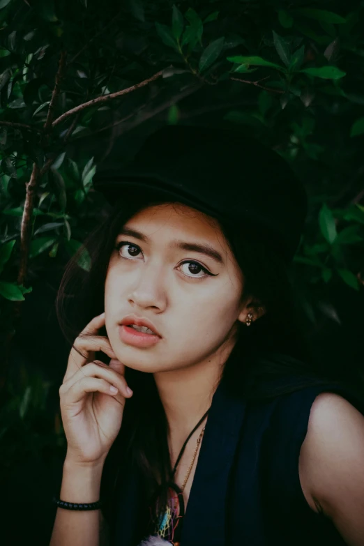 a woman in a black hat talking on a cell phone, trending on pexels, realism, portrait of a japanese teen, pouty lips, south east asian with round face, ((portrait))