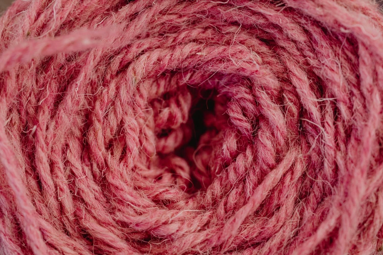 a close up of a ball of yarn, an album cover, pexels, ((pink)), maximum natural texture, spiral, crimson