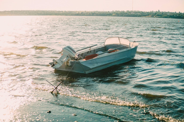 a small boat sitting on top of a body of water, by Pamela Ascherson, unsplash, auto-destructive art, 1990s photograph, water-cooled, grey, william eggleston