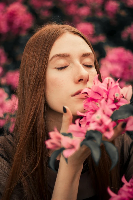 a woman smelling a pink flower with her eyes closed, inspired by Elsa Bleda, pexels contest winner, renaissance, ( redhead, portrait of kim petras, humanoid flora, high quality upload