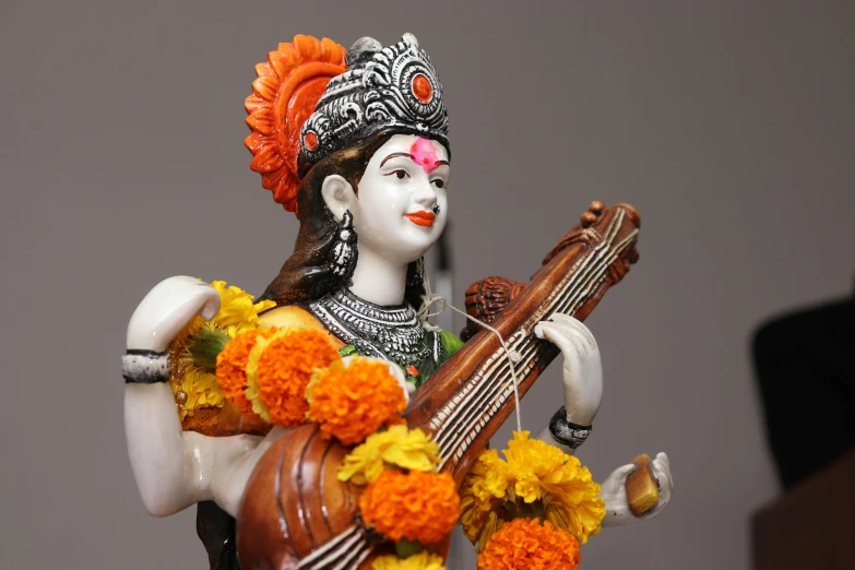 a statue of a woman playing a guitar, by Carey Morris, samikshavad, avatar image, getty images, attractive male deity, shot on sony a 7