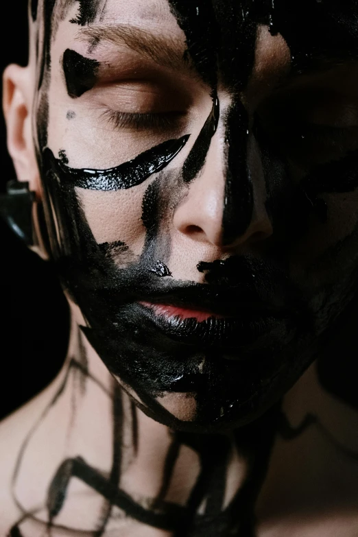 a close up of a person with black paint on their face, a charcoal drawing, trending on pexels, antipodeans, glossy skin, androgynous person, messy lines, face and body