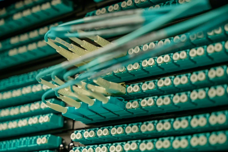 a close up of a bunch of wires, by Matija Jama, shutterstock, white and teal metallic accents, servers, instagram picture, optical fiber
