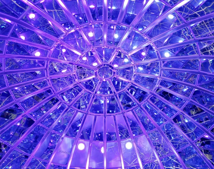 a ceiling filled with lots of purple lights, inspired by Buckminster Fuller, flickr, under glass dome, blue and purple tones, 🦑 design, lots of glass details