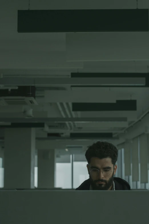 a man sitting in front of a laptop computer, poster art, inspired by Youssef Howayek, pexels contest winner, an empty office hallway, overcast! cinematic focus, a portrait of rahul kohli, 16k resolution:0.6|people