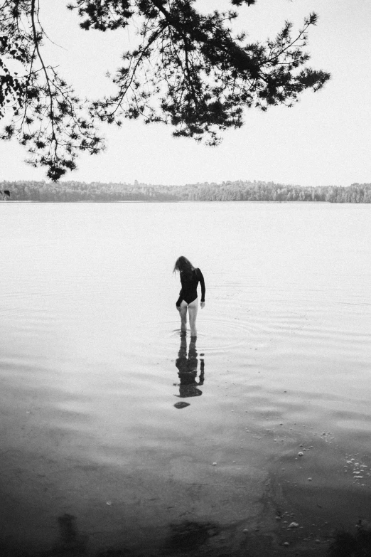 a person standing in a body of water, a black and white photo, by Bascove, the fall of summer, -n 6, minn, julia hetta