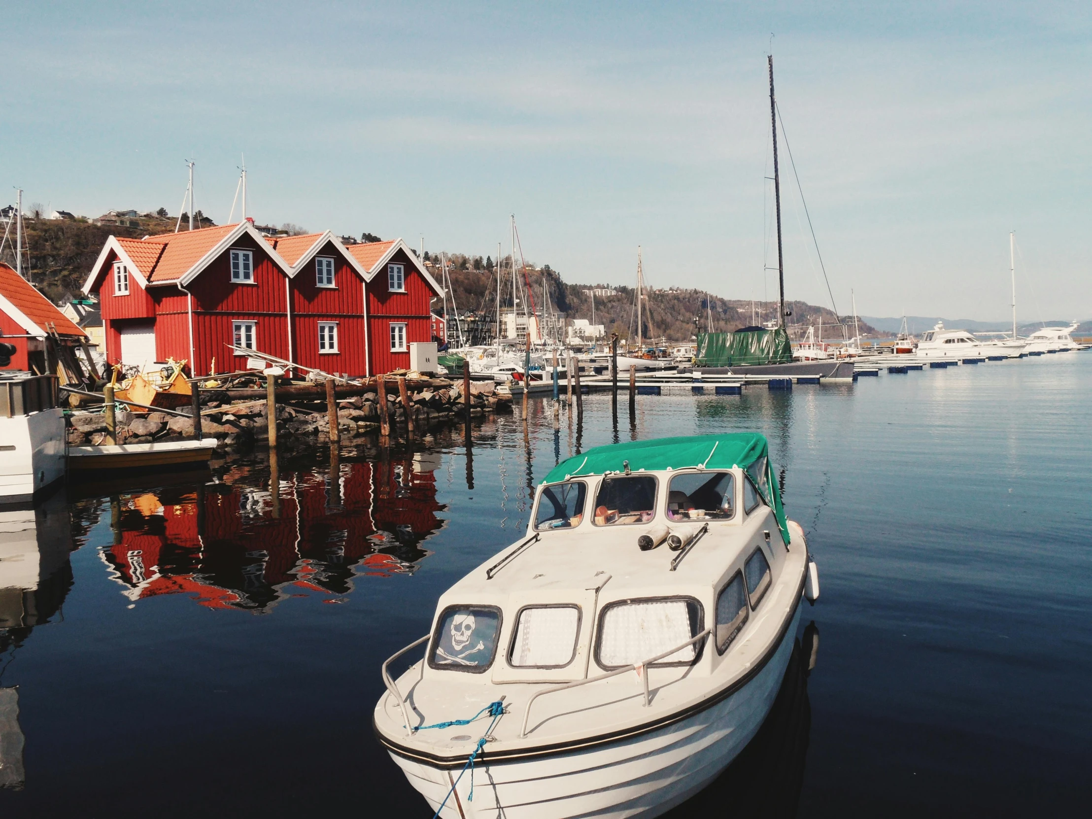 a white boat sitting on top of a body of water, inspired by Wilhelm Marstrand, pexels contest winner, hurufiyya, fishing village, crimson themed, hygge, family friendly