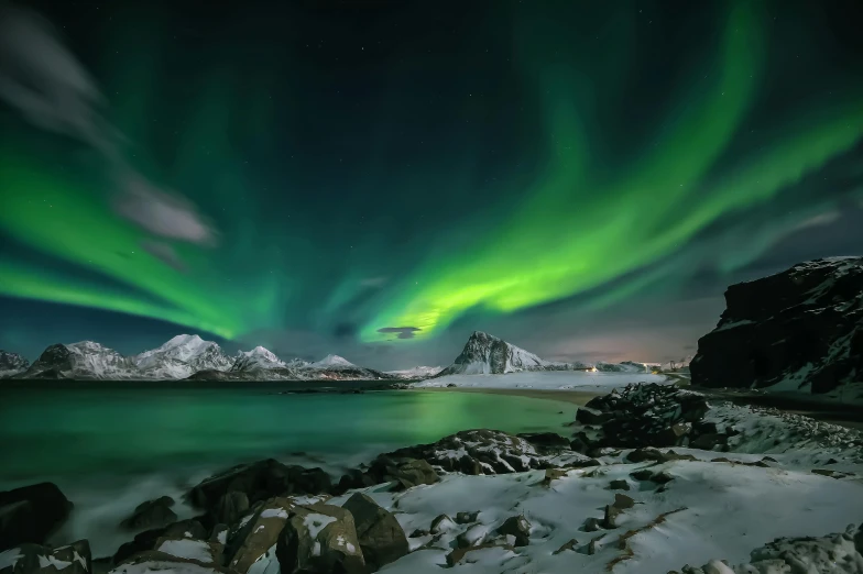 the aurora lights in the sky over a body of water, pexels contest winner, icy mountains in the background, nordic, national geograpic, grey