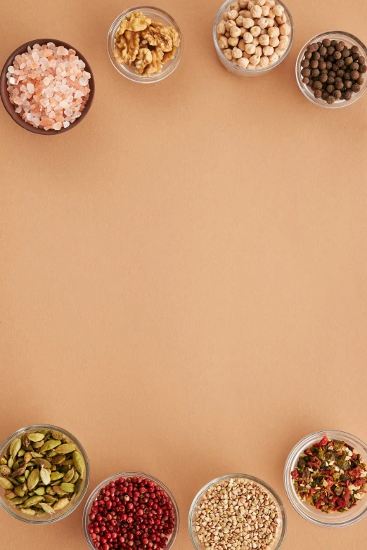 a variety of nuts and seeds arranged in a circle, a picture, trending on pexels, toned orange and pastel pink, square, chefs table, banner