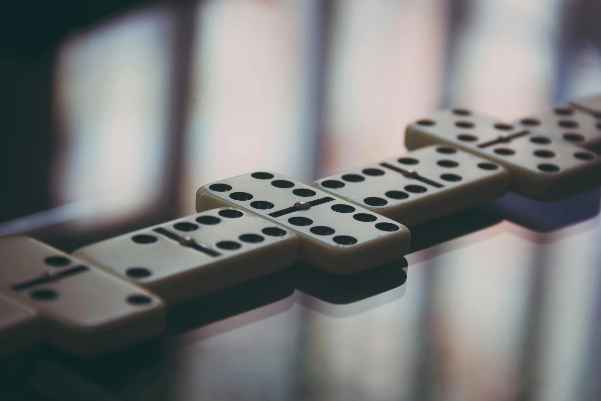 a row of dominos sitting on top of a table, by Daniel Lieske, pexels contest winner, made of dots, which splits in half into wings, mobile game, white