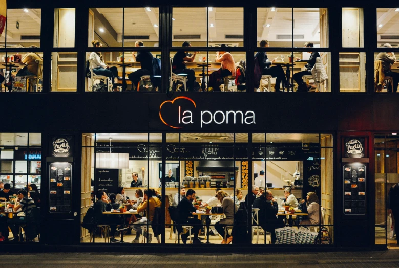 a group of people sitting at tables outside of a restaurant, by Gina Pellón, unsplash contest winner, arte povera, anemone, modern lush condo as shopfront, with names, late at night