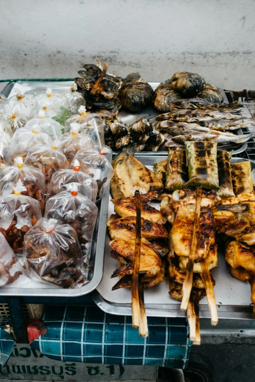 a table topped with lots of different types of food, by Daniel Lieske, pexels contest winner, dau-al-set, laos, grilled chicken, square, shops
