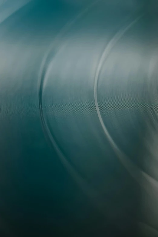 a man riding a snowboard down a snow covered slope, an album cover, by Doug Ohlson, unsplash, lyrical abstraction, flowing teal-colored silk, macro up view metallic, made of brushed steel, spinning records