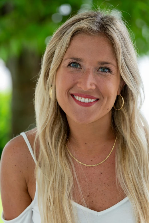 a woman with long blonde hair posing for a picture, vacation photo, portrait photo of a backdrop, slightly tanned, rj palmer