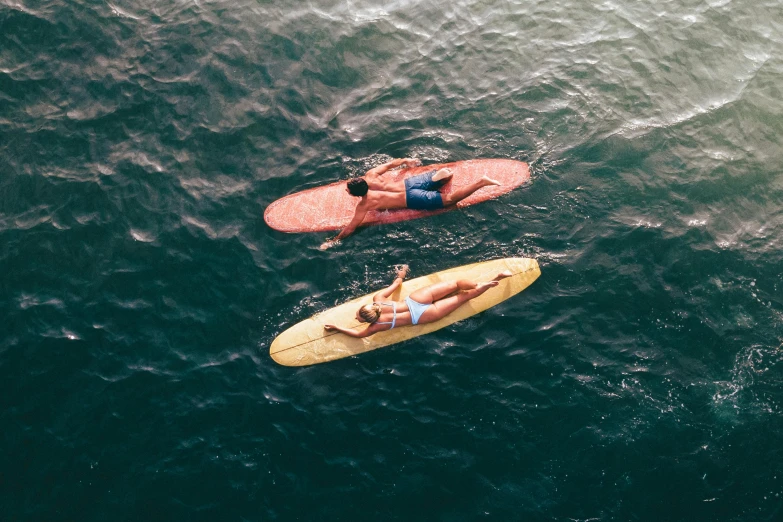 a couple of people riding surfboards on top of a body of water, by Carey Morris, pexels contest winner, flatlay, coloured, thumbnail, tan