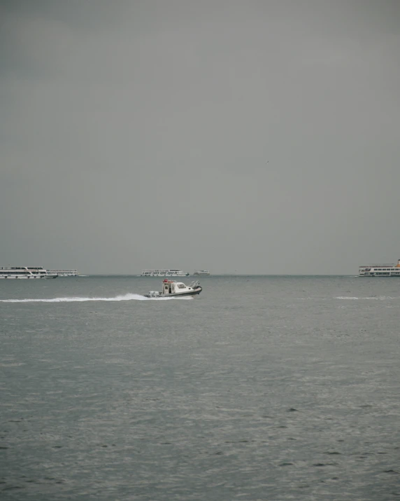 a couple of boats that are in the water, grey skies, istanbul, manila, 🚿🗝📝