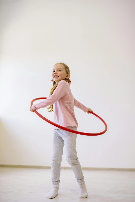 a little girl playing with a hula hoop, by Nina Hamnett, feedback loop, indoor, young teen, promo image