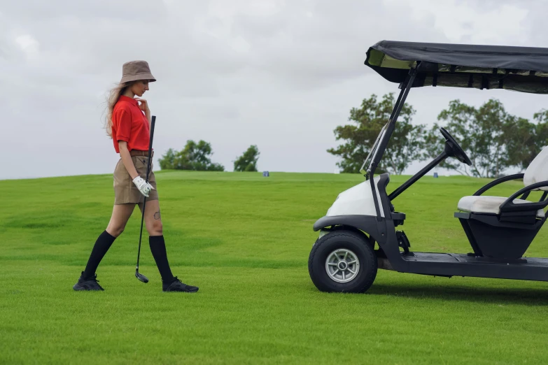 a woman walking next to a golf cart, profile image, lachlan bailey, high resolution image, golf course