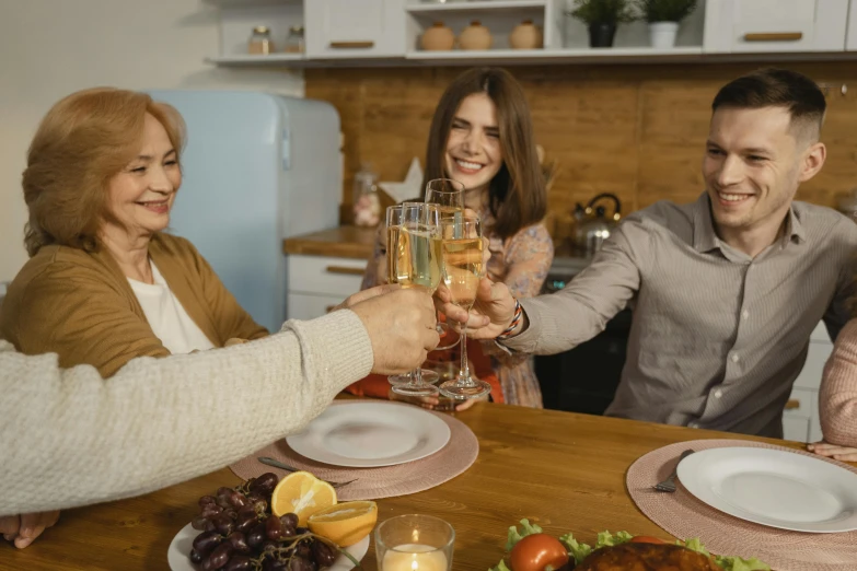 a group of people toasting at a dinner table, a portrait, pexels contest winner, husband wife and son, avatar image, attractive photo, professional image