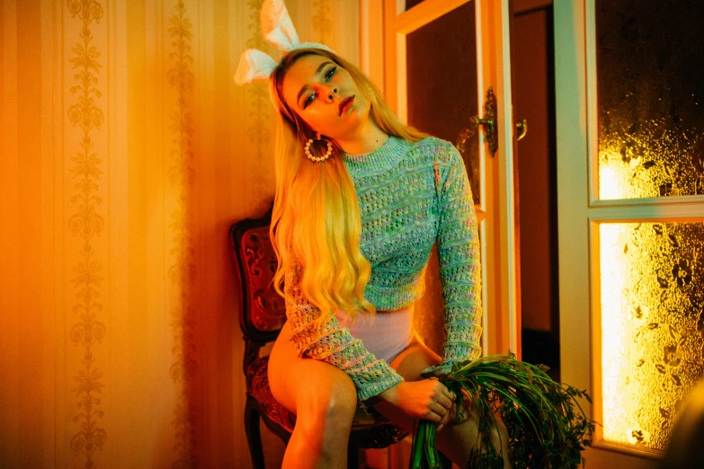 a woman sitting on top of a chair next to a window, an album cover, inspired by Elsa Bleda, trending on pexels, rococo, beautiful lady with bunny ears, portrait of kim petras, playboy style, late evening