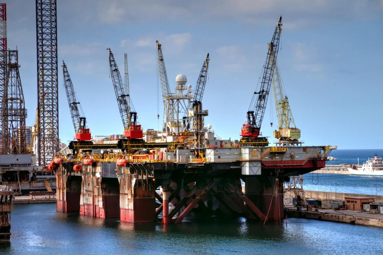 an oil platform in the middle of a body of water, pexels contest winner, hurufiyya, three masts, in 2 0 1 2, striking colour, fully functional