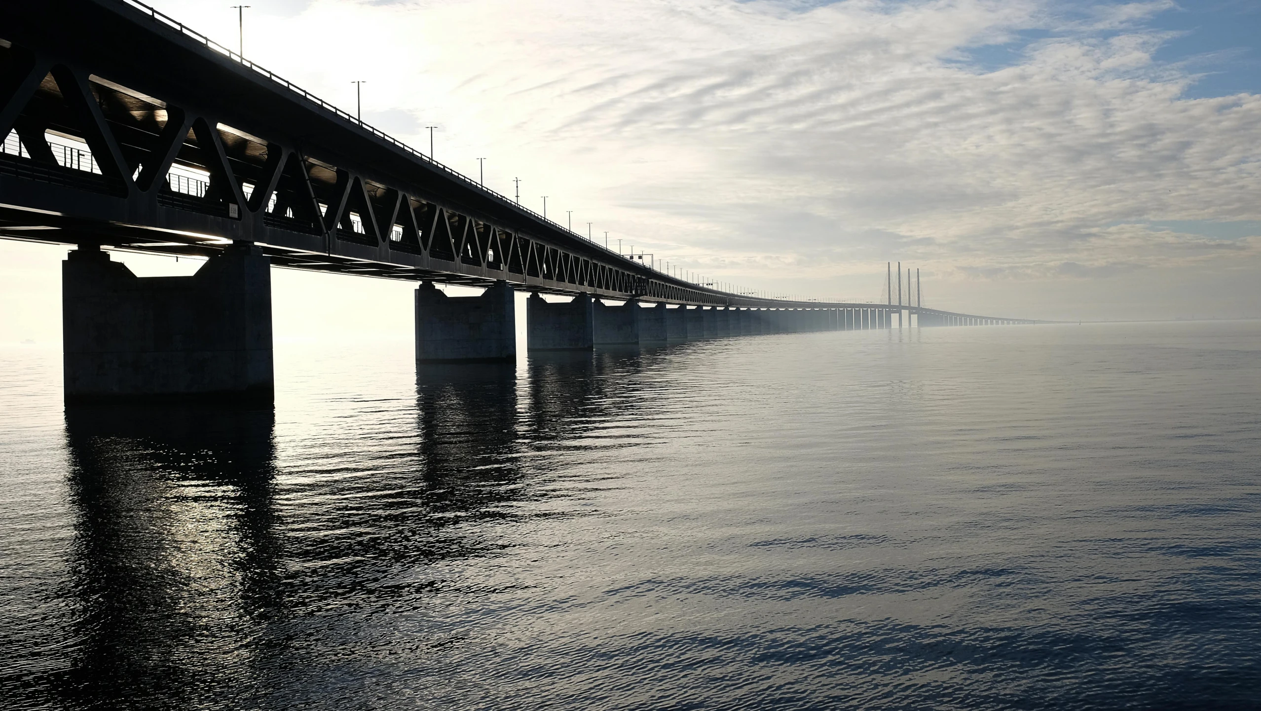 a bridge over a body of water under a cloudy sky, by Jens Søndergaard, pexels contest winner, 2 5 6 x 2 5 6 pixels, scientific photo, panels, hyperrealism photo