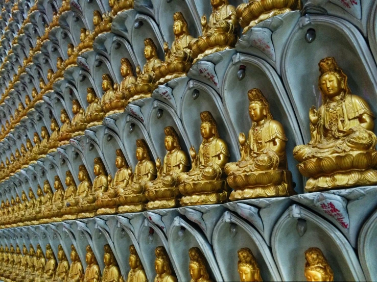 a group of golden buddha statues sitting on top of a wall, a picture, by Shen Che-Tsai, symmetry!!, underground temple, avatar image, shanghai