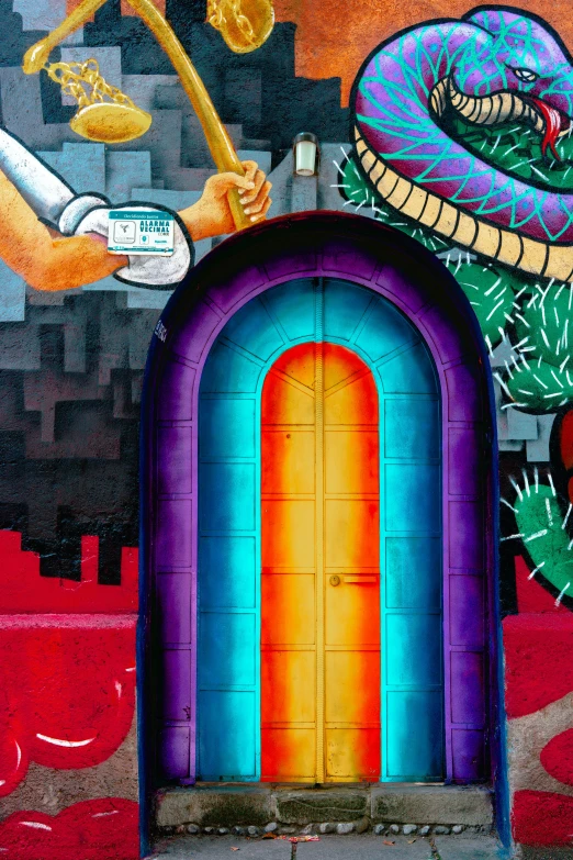 a colorful mural on the side of a building, inspired by Hundertwasser, pexels contest winner, graffiti, arched doorway, quetzalcoatl, gate to hell, downtown mexico