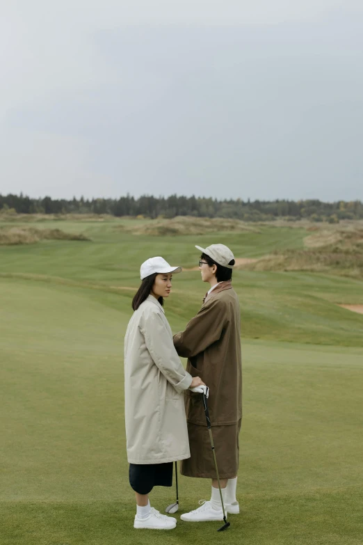 two women standing next to each other on a golf course, by Adriaen Hanneman, unsplash, renaissance, straw hat and overcoat, gif, romantic couple, ruan jia and fenghua zhong