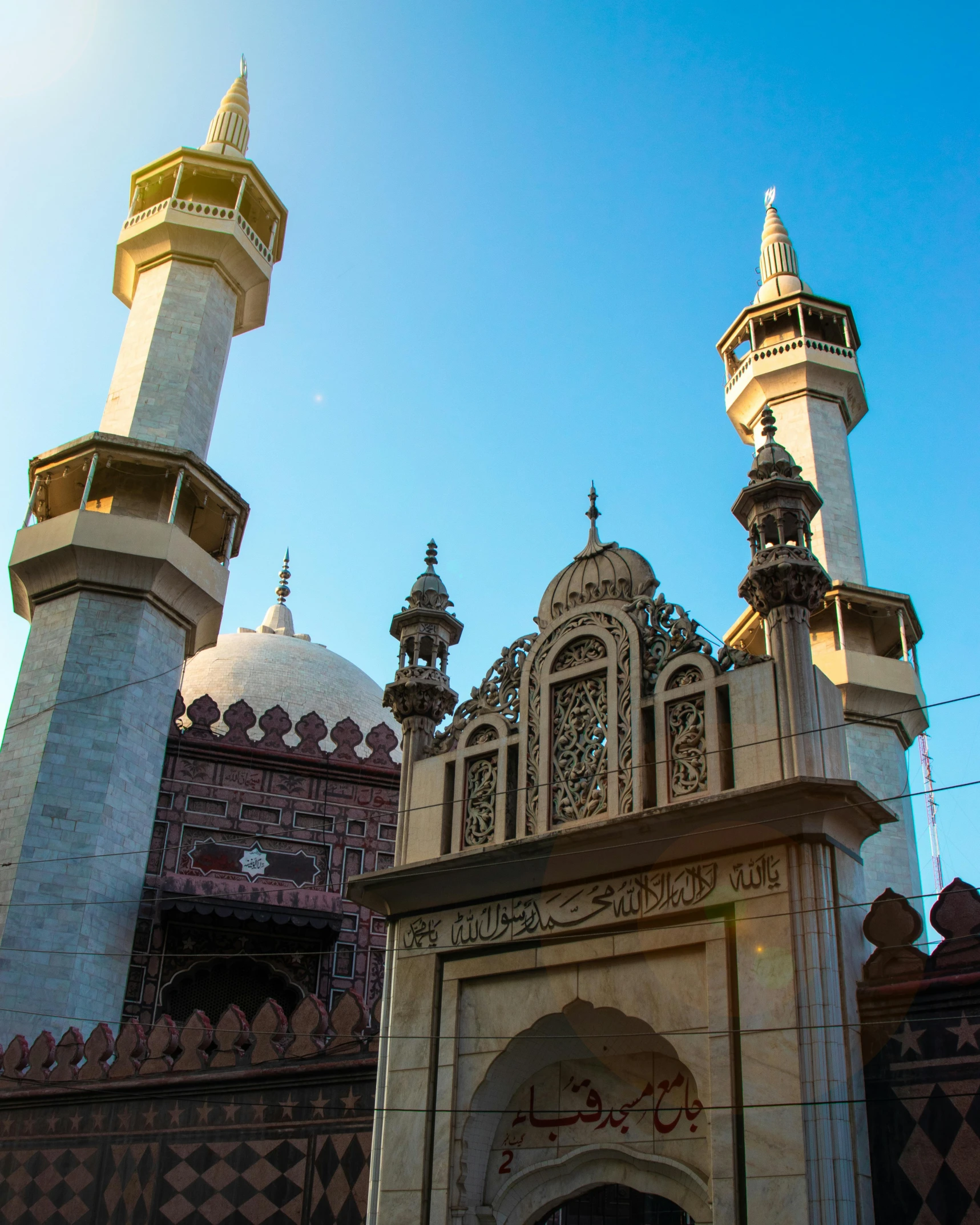 a group of people standing in front of a building, islamic architecture