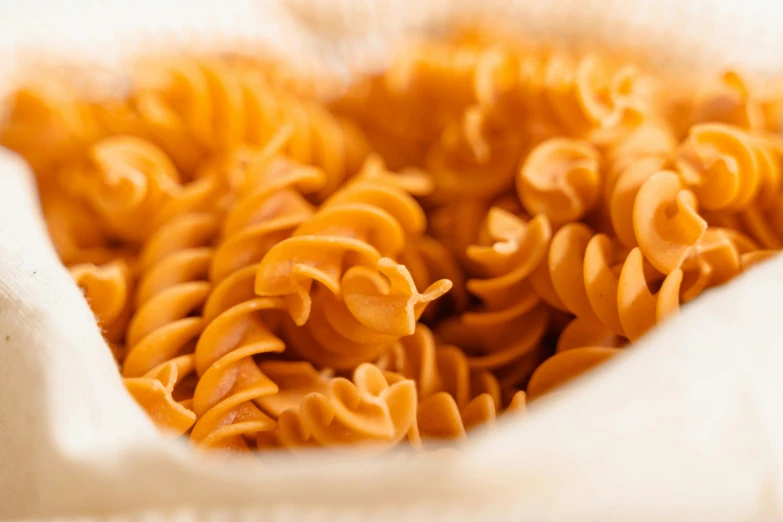 a close up of pasta in a paper bag, a macro photograph, unsplash, spiralling, orange fluffy spines, cooked, really realistic