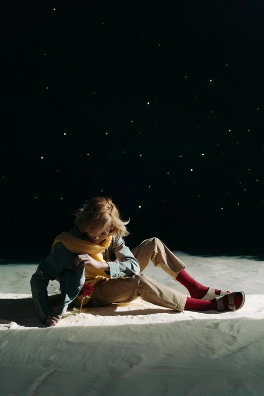 a little girl sitting on top of a snow covered slope, an album cover, inspired by jeonseok lee, trending on pexels, star(sky) starry_sky, laying on sand, profile pic, official vuitton editorial