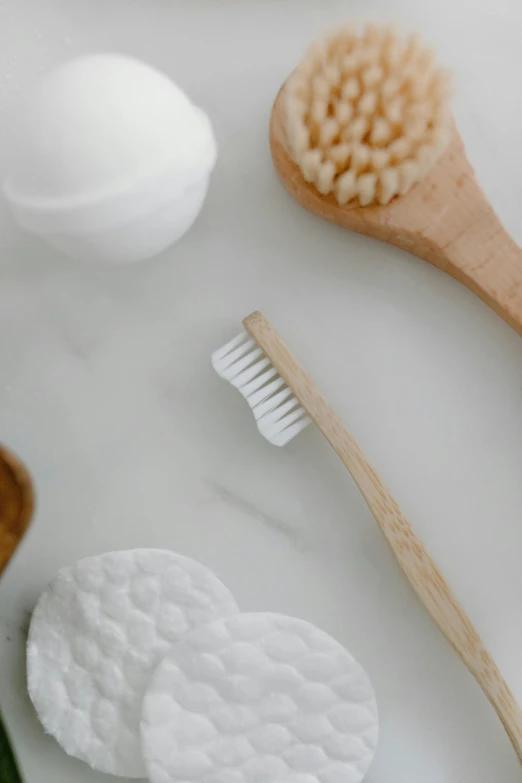 a couple of wooden spoons sitting on top of a counter, brushes her teeth, detailed product image, silicone skin, on white paper