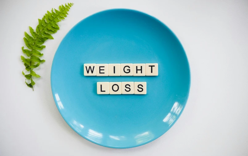 a blue plate with the words weight loss on it, by Rachel Reckitt, pexels contest winner, figuration libre, videogame still, photo shoot, cottagecore!! fitness body, thumbnail