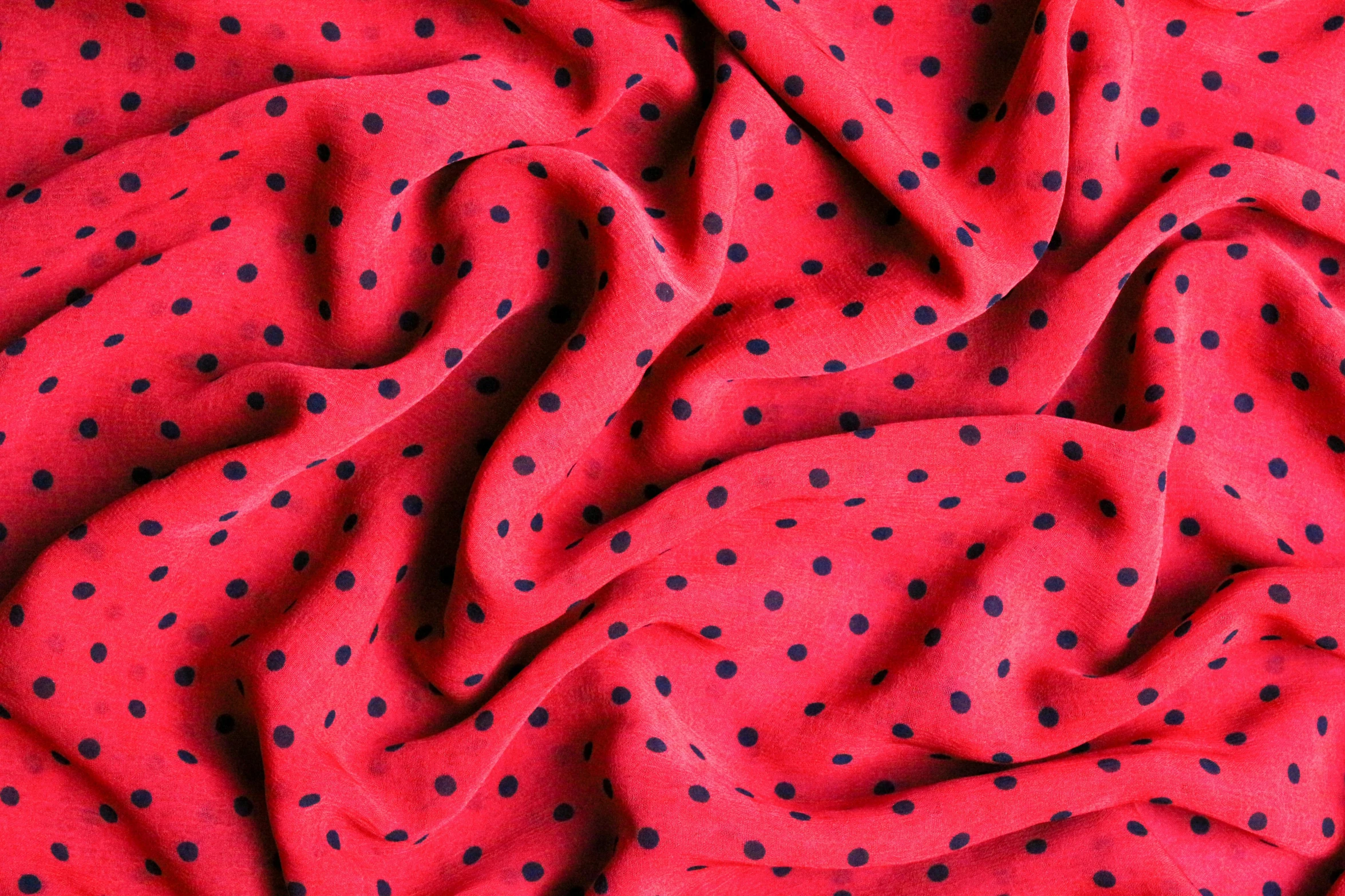 a red fabric with black dots on it, by Carey Morris, pexels, chiffon, 3 colour print, full colour, raspberry