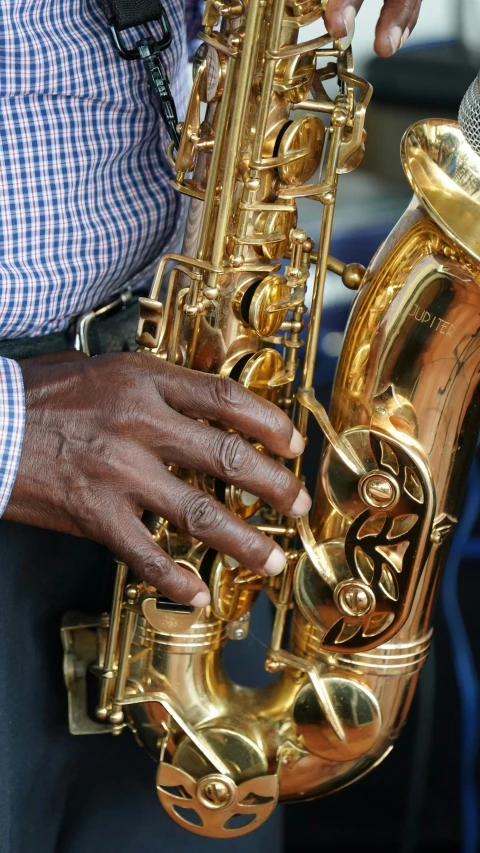 a close up of a person playing a saxophone, by Malvin Gray Johnson, pexels, photorealism, photographed for reuters, ap news, in 2 0 1 5, instagram photo