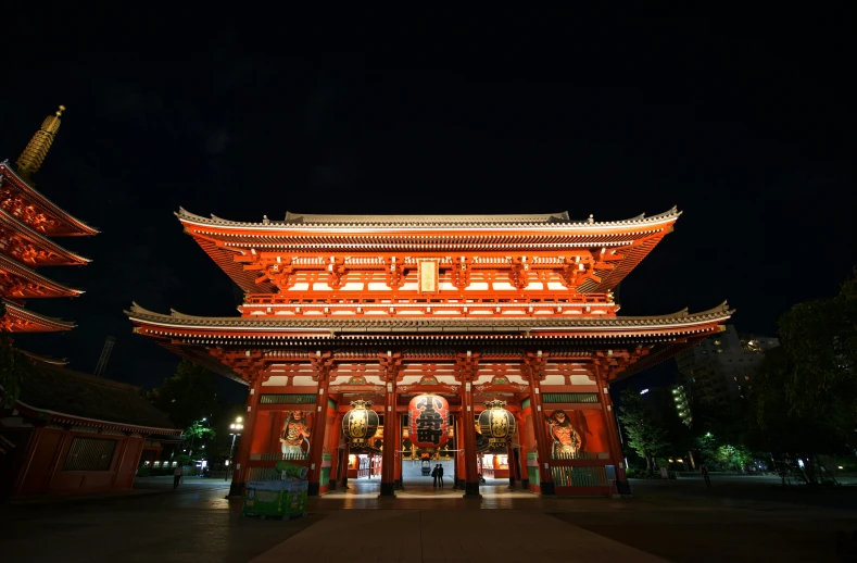 a large red building lit up at night, inspired by Itō Jakuchū, pexels contest winner, massive arch, square, a wooden, holy place