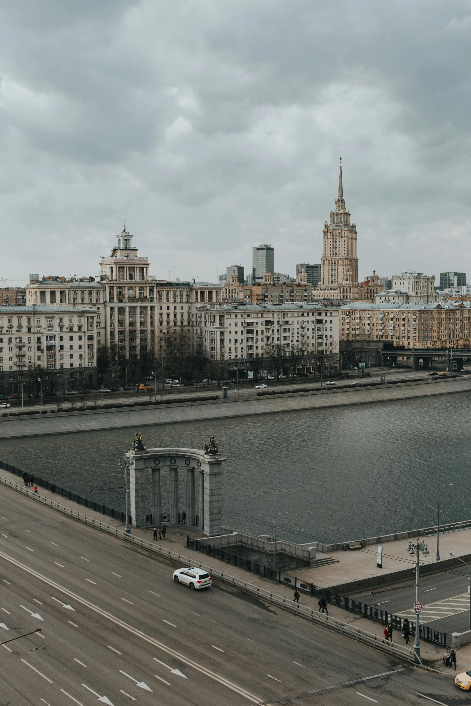 a large body of water next to a city, by Fyodor Rokotov, pexels contest winner, socialist realism, overcast gray skies, street of moscow, high quality photo, 2022 photograph