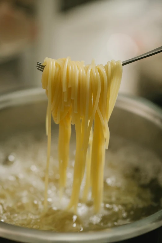 spaghetti being cooked in a skillet with a fork, a picture, by Matt Cavotta, pexels, ultrafine detail ”, butter, gif, ribbon