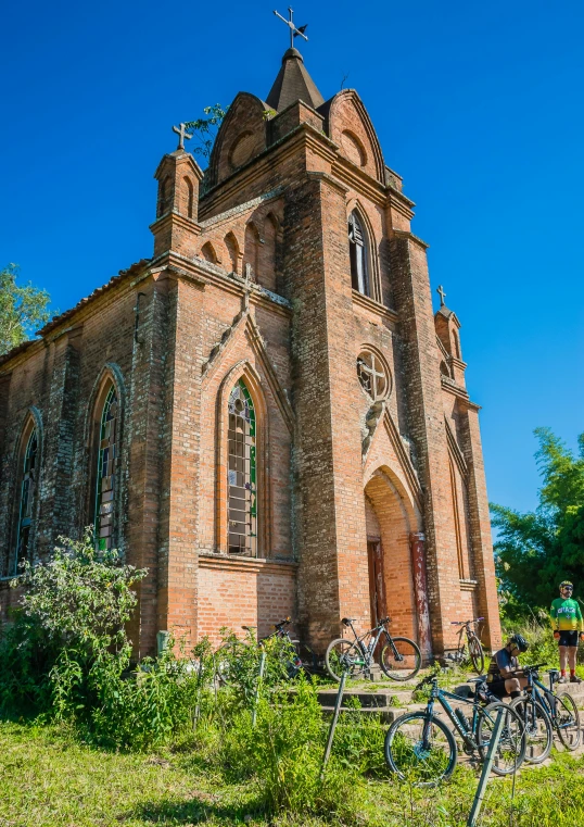 a church with bicycles parked in front of it, by Jan Tengnagel, romanesque, madagascar, profile image, lush surroundings, square