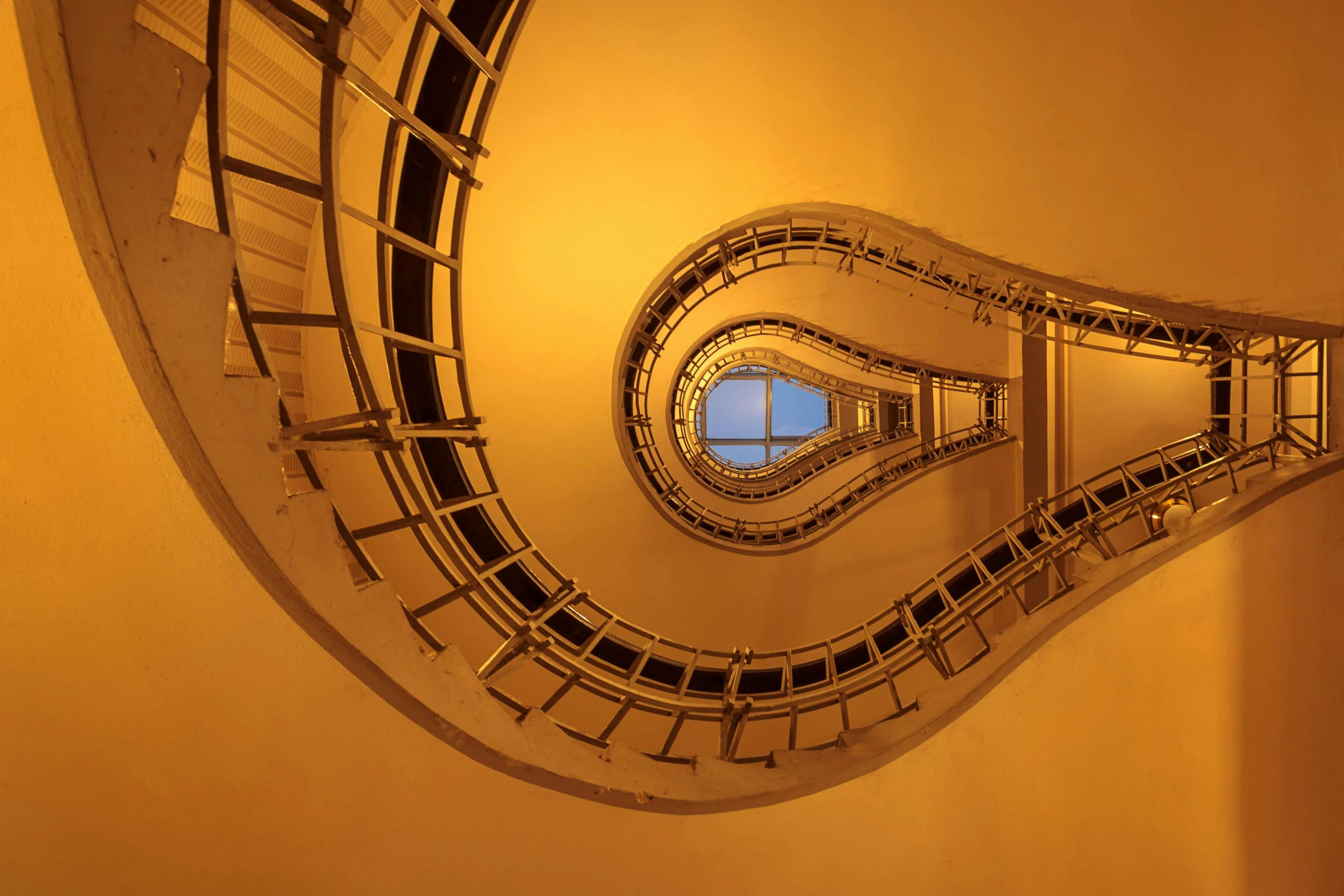 a spiral staircase leading to the top of a building, by János Nagy Balogh, unsplash contest winner, art nouveau, golden hues, benoit mandelbrot, hasselblad photography, full shot photograph