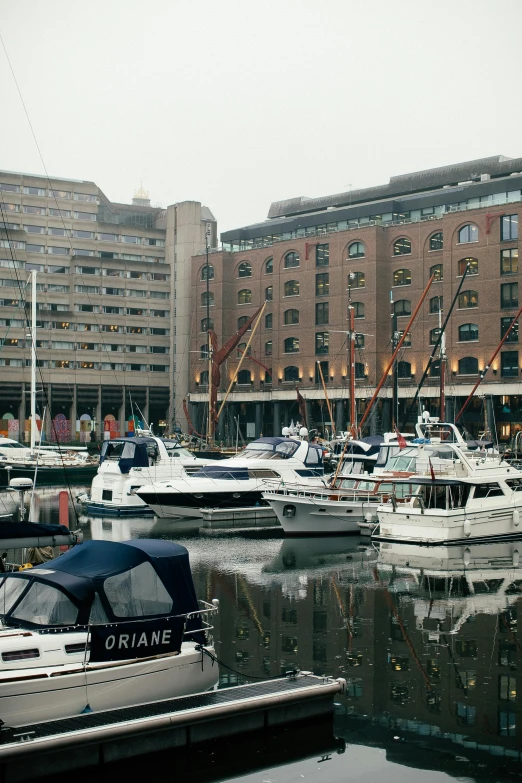 a bunch of boats that are in the water, a photo, inspired by Thomas Struth, the neat and dense buildings, uk, exterior shot, docked at harbor