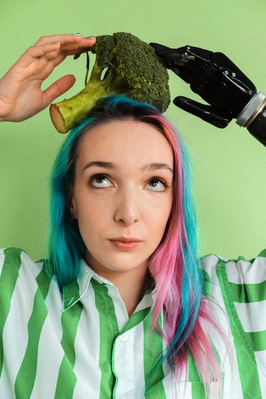 a woman with blue, green and pink hair combing a piece of broccoli, an album cover, by Jessie Alexandra Dick, unsplash, twitch streamer / gamer ludwig, saoirse ronan, coral snakes grow from her head, instagram photo