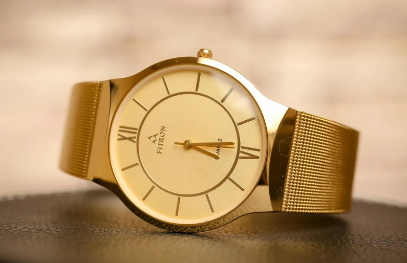 a close up of a watch on a table, an album cover, by Alfred Jensen, pexels contest winner, modernism, gold metal, thumbnail, full face, perfect shape