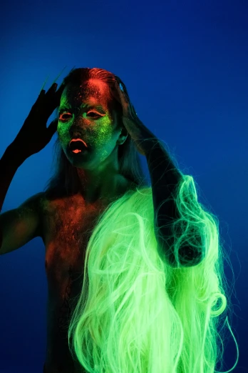 a man with long hair and green glow on his face, inspired by Ren Hang, pexels contest winner, conceptual art, 3 d neon art of a womens body, showstudio, hair made of shimmering ghosts, blue and green and red tones