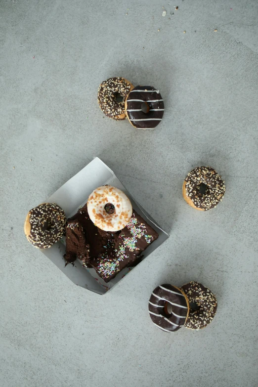 a box of donuts with chocolate frosting and sprinkles, by Nicolette Macnamara, unsplash, square, bronze, do